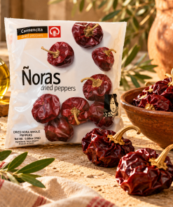 Carmencita Spanish dried ñora peppers 25g package with whole red ñora peppers, olive oil and rustic Mediterranean food styling